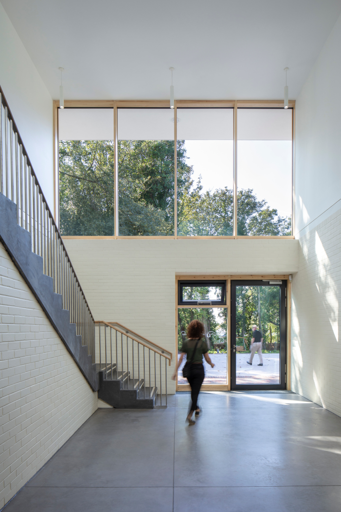 circulation routes are aided by wide, roving corridors and staircases that are flooded with daylight. Image Credit: GILLIAN HAYES