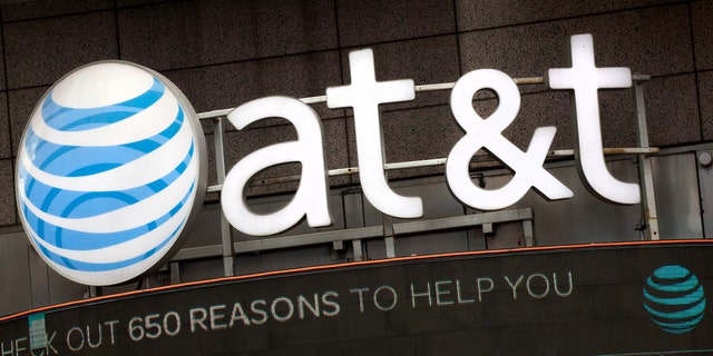 FILE - In this Oct. 24, 2016, file photo, the AT&T logo is positioned above one of its retail stores in New York.