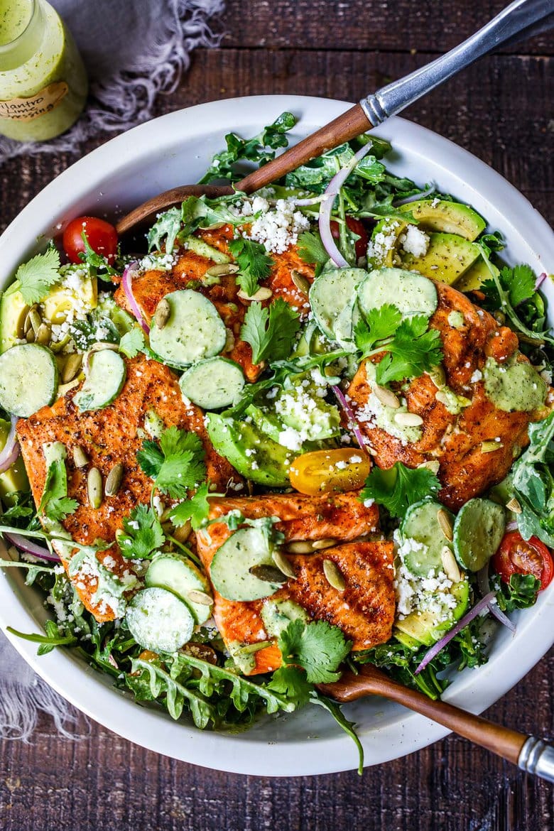 The BEST Grilled Salmon Salad with Avocado, Arugula, Cucumber, Pepitas, Cotija Cheese & Creamy Cilantro Lime Dressing-perfect for summer barbecues and outdoor gatherings. Chock full of fresh organic produce, not only is this entree salad healthy and easy to make, it's bursting with delicious summertime flavor! Keto and Low-carb.
