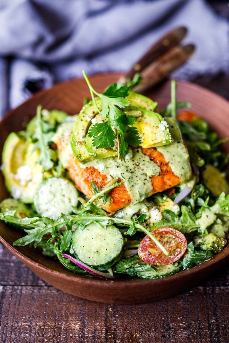 The BEST Grilled Salmon Salad with Avocado, Arugula, Cucumber, Pepitas, Cotija Cheese & Creamy Cilantro Lime Dressing.