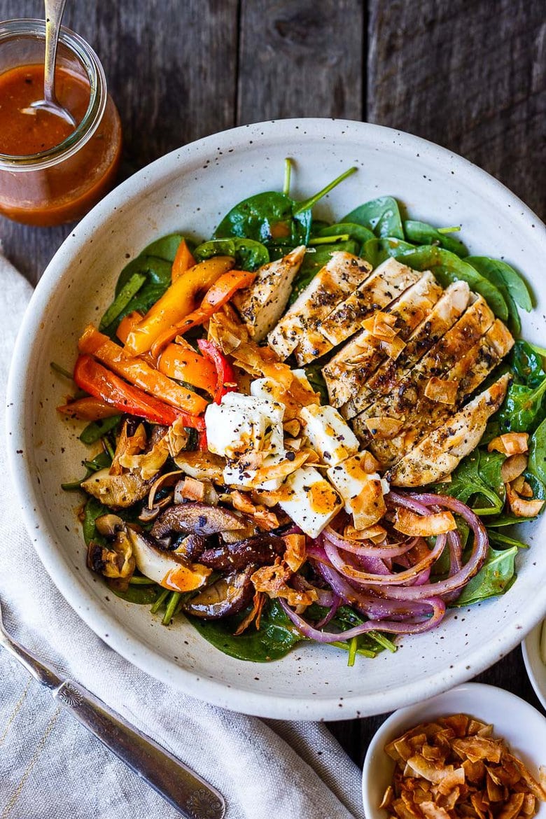 Delicious & hearty Spinach Salad with grilled mushrooms, red onions, sweet peppers, and optional grilled chicken breast, tossed with tangy French Dressing, topped with Coconut Bacon, Feta and hard-boiled eggs. A tasty entree-sized salad, perfect for dinners on the patio! 
