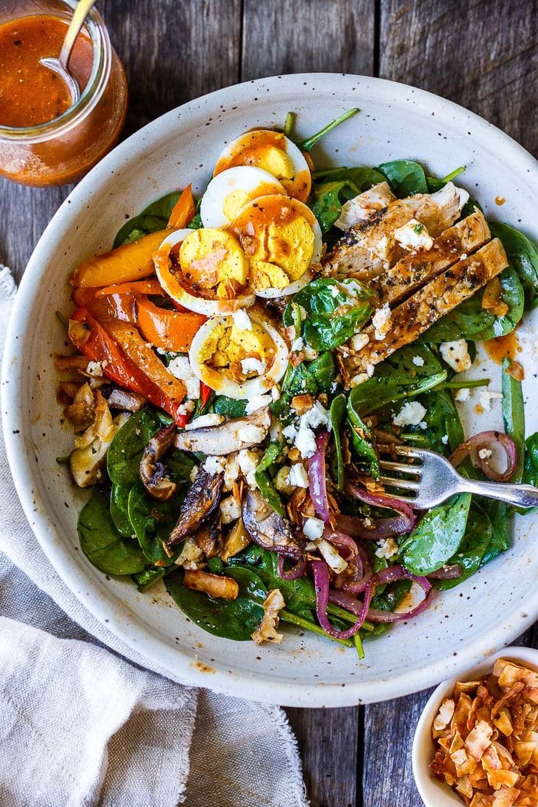 Delicious & healthy Spinach Salad with grilled mushrooms, red onions, sweet peppers and herby grilled chicken, tossed with French Dressing.