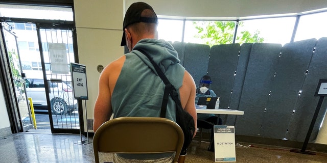 A man awaits his Jynneos vaccine dose as the city launches its first inoculation campaign against monkeypox in Washington, U.S., June 28, 2022. 