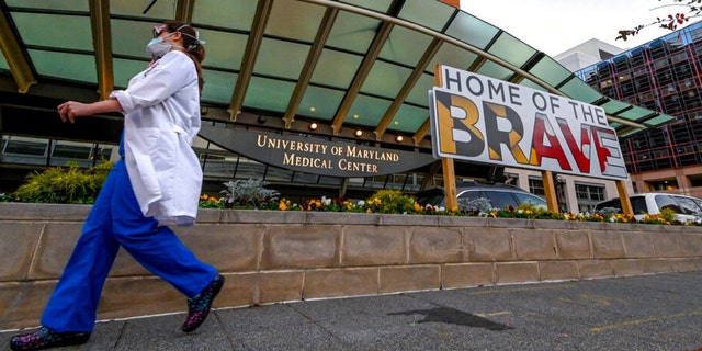 A doctor passes in front of University of Maryland Medical Center in Baltimore, Dec. 11, 2020. 